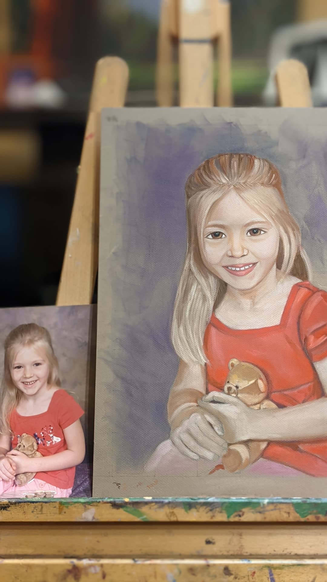 Oil portrait of a young girl holding a teddy bear by Iwona Staszewski
