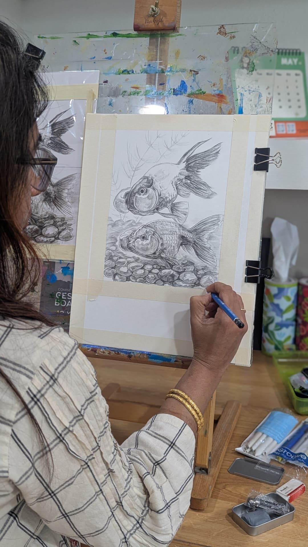 Adult student drawing goldfish in graphite pencil