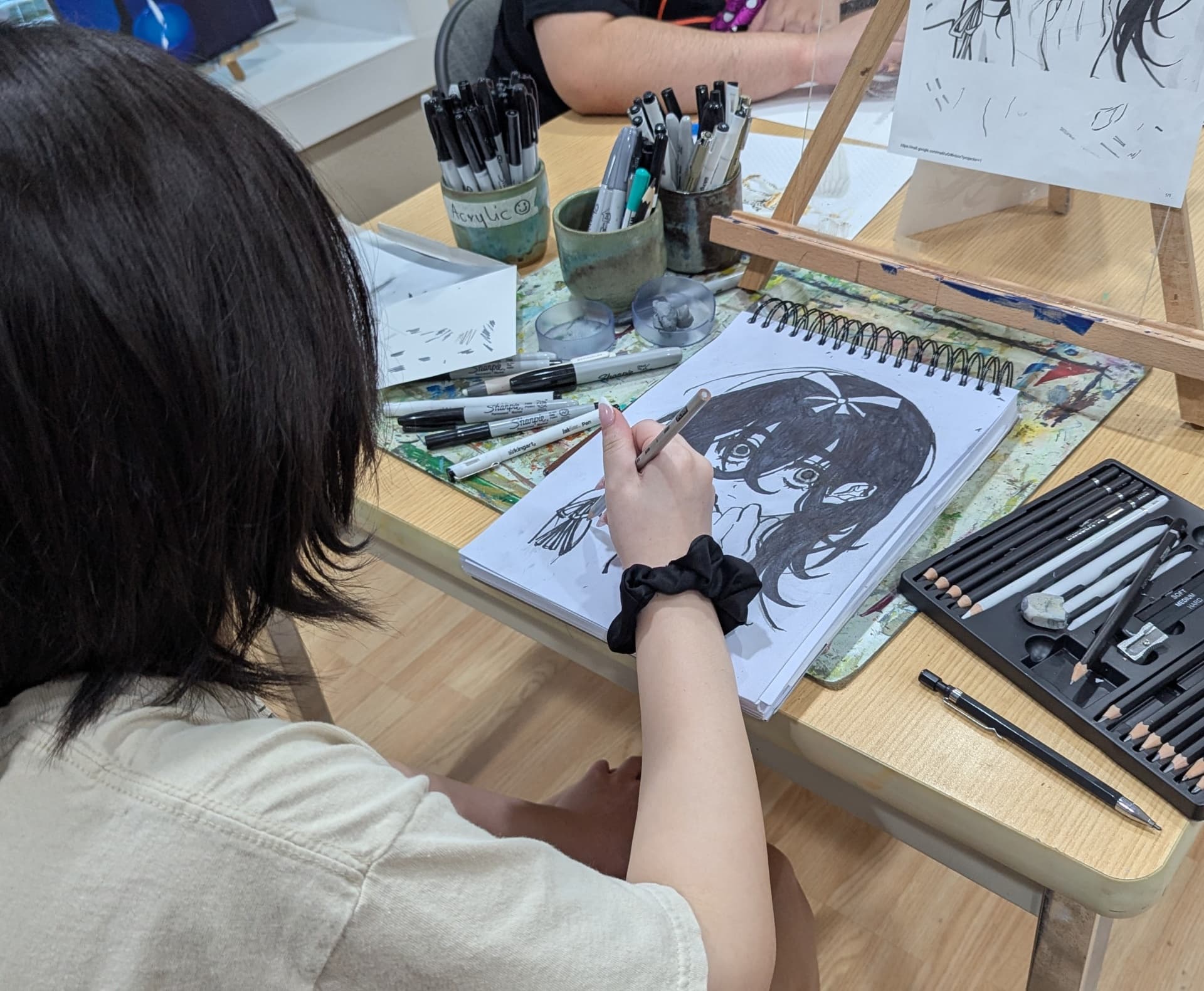 Teen anime-style drawing on a sketchbook