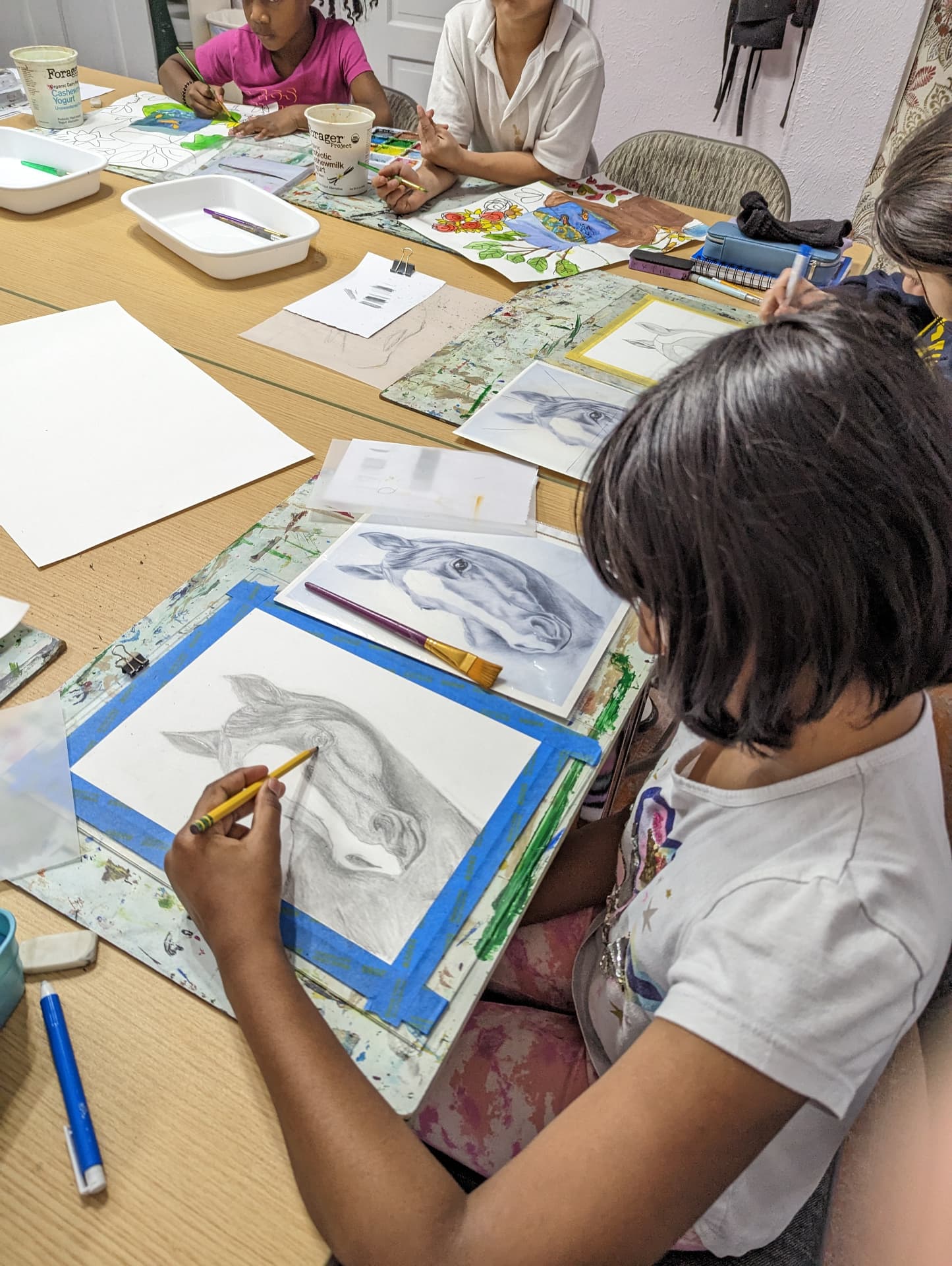 Kids drawing horses in pencil at Art Adventure Studio