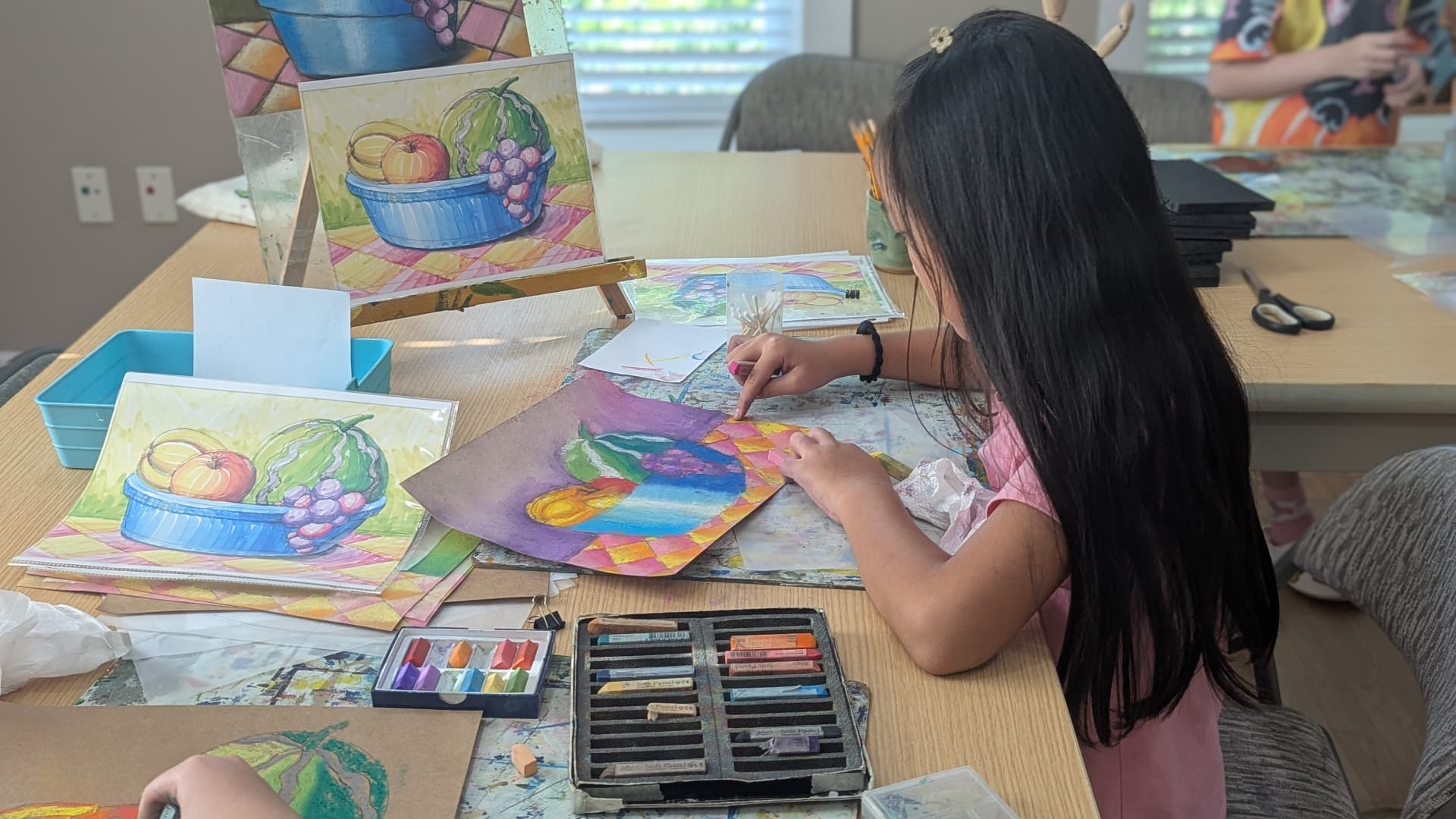 Student working on a pastel still life