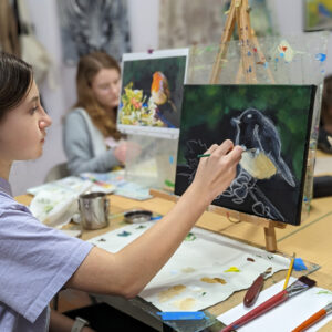 Student painting a bird in the Art Adventure Studio